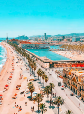 This image shows Barceloneta Beach in Barcelona, a popular spot for both locals and tourists to relax, sunbathe, swim, and enjoy the Mediterranean sea.

