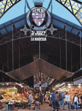 This image shows the bustling Mercat de la Boqueria in Barcelona, a popular market offering fresh produce, seafood, meats, and local delicacies in a colorful and lively atmosphere.

