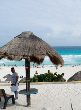 This image shows Playa Marlin, a serene and less crowded beach in Cancún, ideal for those looking to escape the hustle and enjoy a relaxing day in the sun.