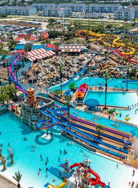 This image shows vibrant water slides and pools at Big Kahuna’s Water Park, with families enjoying thrilling rides and splashes in a fun environment.