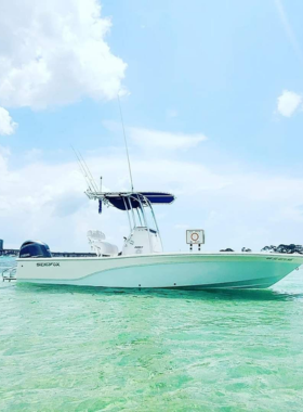  This image shows a fishing charter boat in Destin with anglers casting their lines, surrounded by clear blue waters and a sunny horizon.