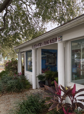 This image shows an exhibit at the Destin History & Fishing Museum, featuring vintage fishing equipment and historical photographs showcasing the city’s heritage.