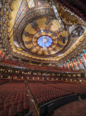  This image shows the lavish interior of the Fox Theatre in Detroit, featuring intricate art deco designs and a majestic stage.