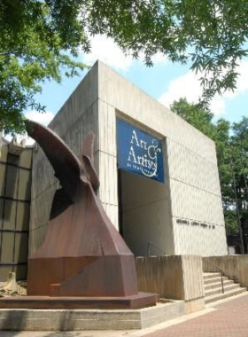 This image shows a quiet exhibit room at the Greenville County Museum of Art, featuring paintings and sculptures. The museum's collection showcases Southern artists and modern masterpieces in a serene atmosphere.