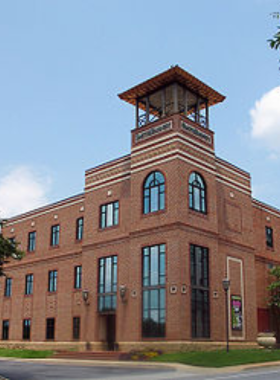 This image shows a live performance at Centre Stage, with actors on a well-lit stage and an intimate audience. The venue offers plays, musicals, and cultural events in Greenville.