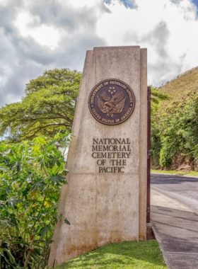 This image shows the National Memorial Cemetery of the Pacific, located in Punchbowl Crater. Rows of white headstones mark the graves of U.S. soldiers, providing a peaceful and respectful setting for reflection and remembrance.