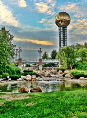 This image shows World’s Fair Park in Knoxville, featuring the iconic Sunsphere. Visitors are enjoying the park’s open spaces, walking paths, and green lawns while exploring exhibits and events.

