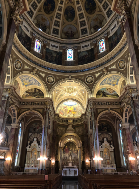 This image shows the stunning interior of the Basilica of St. Josaphat, with its soaring ceiling, intricate stained-glass windows, and a peaceful atmosphere inside the church.
