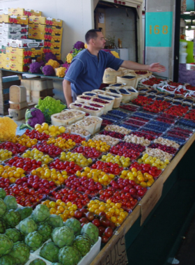 This image shows a vibrant display of fresh local produce at Jean-Talon Market, one of Montreal’s largest public markets, offering a wide variety of fruits, vegetables, and gourmet foods.