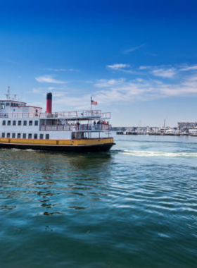 This image shows a cruise boat sailing through the beautiful Casco Bay, offering views of Portland’s harbor and surrounding islands under a bright blue sky.