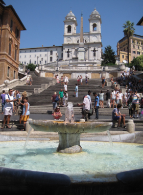 This image shows the Spanish Steps at sunset, a famous gathering spot with beautiful views and lively surroundings.