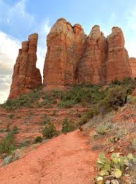 This image shows the challenging Cathedral Rock hike in Sedona, with rocky terrain leading up to a summit that offers panoramic views of the stunning red rock landscape.