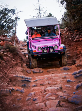 This image shows a thrilling Pink Jeep Tour in Sedona, where adventure seekers explore rugged terrains, hidden canyons, and majestic red rock landscapes in a sturdy off-road vehicle.