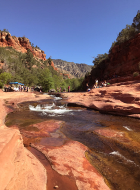 This image shows a mesmerizing sunrise over Sedona, with the first light casting golden hues across the famous red rock formations and creating a peaceful atmosphere.