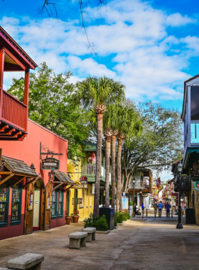 "This image shows St. George Street in St. Augustine, a vibrant pedestrian-only street filled with charming boutiques, cafes, art galleries, and historic landmarks like the Oldest Wooden Schoolhouse. It captures the lively atmosphere and the blend of history and culture that defines the heart of the city."