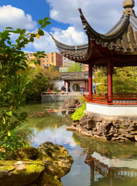 "This image shows the tranquil Dr. Sun Yat-Sen Classical Chinese Garden in Vancouver, with koi-filled ponds, lush greenery, and traditional Chinese architecture creating a peaceful escape."