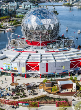 "This image shows a family exploring interactive exhibits at Science World in Vancouver, engaging with science displays and enjoying hands-on learning experiences."