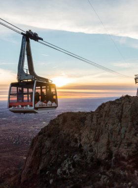 This image shows the Sandia Peak Tramway, a cable car ascending the Sandia Mountains with breathtaking views of Albuquerque's landscape.