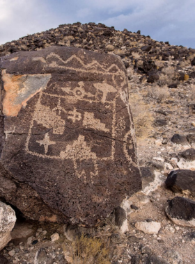  This image shows a hiking trail at Petroglyph National Monument, lined with ancient rock carvings and desert landscapes.

