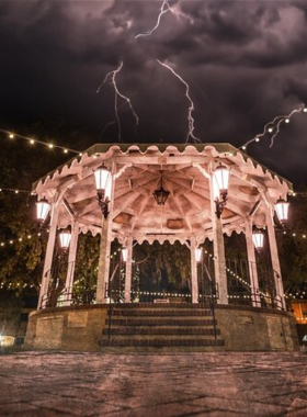 This image shows a guided ghost tour at night in Old Town Albuquerque, highlighting historic streets with a spooky ambiance.