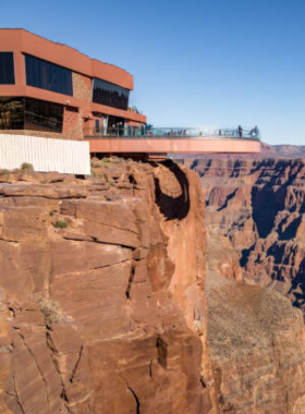 This image shows the breathtaking panoramic view of the Grand Canyon, showcasing its vast and colorful rock formations carved by the Colorado River, highlighting the natural beauty and the grandeur of this iconic landmark in Arizona