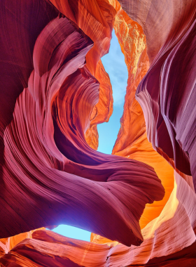  This image shows the stunning beams of light shining through the narrow passageways of Antelope Canyon, highlighting the beautiful sandstone formations that create a mesmerizing and otherworldly atmosphere for visitors to admire.