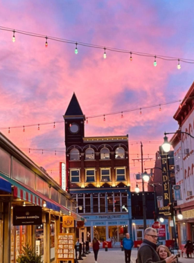 "This image shows a vibrant streetscape in one of Cincinnati's neighborhoods, showcasing the mix of old and new architecture, with bustling streets, shops, and eateries."