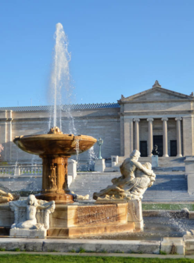 This image shows a visitor exploring an art exhibit at the Cleveland Museum of Art, surrounded by beautiful paintings and sculptures from various cultures and time periods.