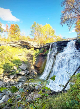 This image shows a picturesque view of Cuyahoga Valley National Park, with rolling hills, wooded areas, and a winding river, offering visitors a serene experience in nature.