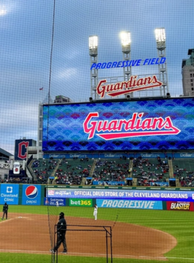  This image shows a lively Cleveland Guardians baseball game at Progressive Field, with excited fans cheering from the stands as the team plays on the field, showcasing the city's sports culture and energetic atmosphere.