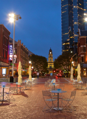 This image shows the vibrant life in Sundance Square, a bustling area in Fort Worth where modern-day shops, restaurants, and outdoor events blend seamlessly with historical architecture, offering both cultural experiences and lively urban entertainment.