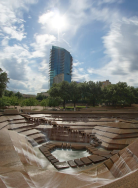 This image shows the Quiet Pool at the Fort Worth Water Gardens, a peaceful and meditative space within the urban park. Visitors can enjoy the calming sounds of cascading water while surrounded by beautiful landscaping.