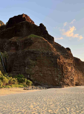 "This image shows a tranquil boat tour on the Wailua River, surrounded by lush tropical landscapes and towering waterfalls, offering a serene experience on Kaua’i."