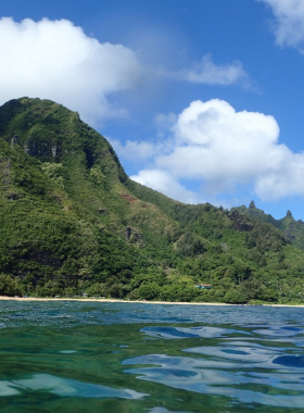 "This image shows Tunnels Beach, known for its beautiful coral reef, where snorkelers can explore vibrant marine life and crystal-clear waters on Kaua’i’s North Shore."