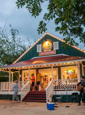 "This image shows a colorful sunset over Hanapepe Town, Kaua’i’s art hub, with its charming streets and galleries illuminated by the soft glow of evening light."