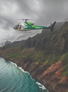 "This image shows a helicopter tour over Kaua’i, offering an aerial view of the island’s stunning landscapes, including the Napali Coast, waterfalls, and lush valleys."