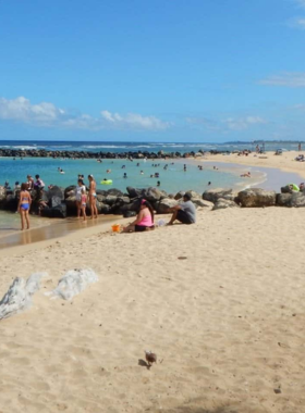 "This image shows a beautiful sunrise at Lydgate Beach Park on Kaua’i’s East Shore, with soft golden light casting over calm waters, ideal for morning relaxation."