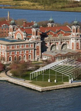 This image shows the historic Ellis Island building, with visitors walking toward the museum that tells the story of America’s immigrant heritage.