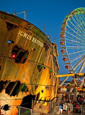 This image shows the lively Wildwoods boardwalk, with vibrant amusement rides, food stalls, and families enjoying a fun-filled day.