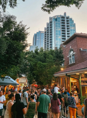  This image shows vibrant stalls at Raleigh City Market, offering handmade goods, fresh produce, and local crafts in a lively atmosphere.