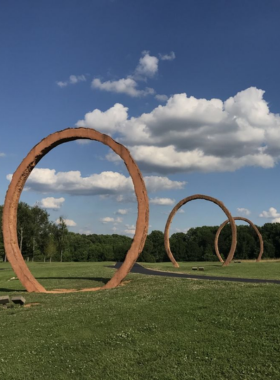 This image shows a nature trail adorned with unique art installations in Ann and Jim Goodnight Museum Park, blending creativity with natural beauty.