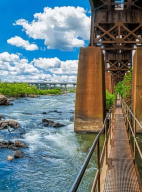 This image shows a scenic hiking trail at the James River Park System in Richmond. The park offers miles of trails for outdoor enthusiasts, with opportunities for hiking, biking, and enjoying the natural beauty of the James River and its surroundings.

