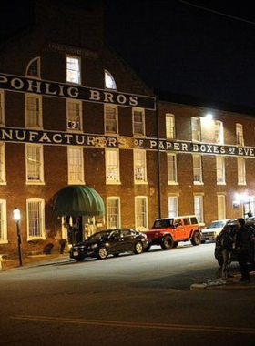 This image shows a group of visitors on a Richmond Ghost Tour at night, exploring the city's haunted sites. The tour guides guests through historic locations, sharing spooky stories and legends about Richmond's mysterious past and supernatural encounters.