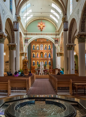 This image shows the Cathedral Basilica of St. Francis of Assisi, showcasing its French Romanesque Revival architecture and beautiful stained glass windows.