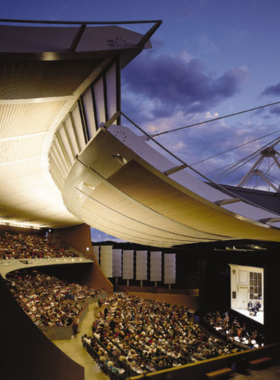 This image shows the Santa Fe Opera House, a world-class open-air theater with stunning mountain views, hosting exceptional opera performances.