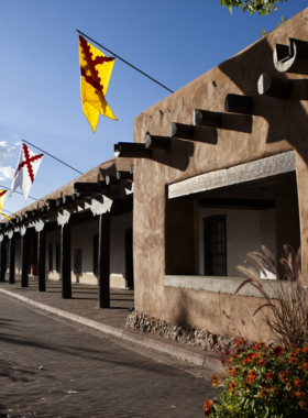  This image shows the Palace of the Governors, one of the oldest public buildings in the U.S., with a rich historical significance and Native American artisan market.