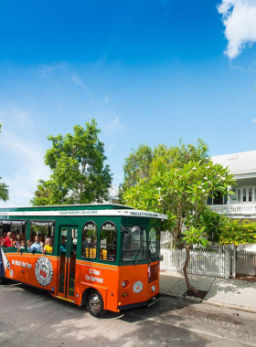 This image shows a Key West Trolley Tour, a popular sightseeing activity where visitors can hop on and off while exploring the city’s historic landmarks and attractions with a knowledgeable guide.