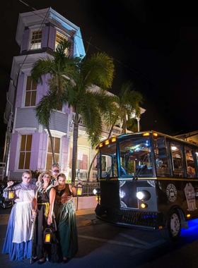 This image shows a group of tourists on a Key West Ghost Tour, walking through the streets at night. The tour explores haunted sites and shares eerie local legends, making for a spooky and engaging experience.