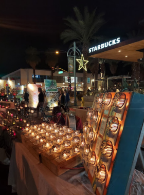  This image shows VillageFest in Palm Springs, a lively street fair with vendors, live music, and colorful streetlights, offering visitors a fun and festive atmosphere every Thursday night.