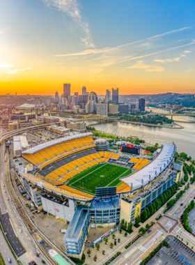 "This image shows Heinz Field Stadium on game day, with fans in black and gold filling the stands. The stadium is known for its energetic atmosphere and riverside views, making it a prominent venue for football fans and events in Pittsburgh."